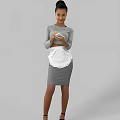 Woman in Gray Dress with White Apron Preparing Food Holding Bowl