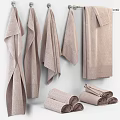 Light Brown Textured Towels Hanging On Wall With Rolled Towels And Soft Finish