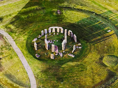 Ancient Stone Circle Structure with Wooden Elements in Lush Green Grassland Area 3d model