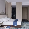 Modern Hotel Guest Room With Wooden Wall White Bed Blue Accent And Patterned Carpet