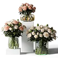 Multiple Transparent Glass Vases With Fresh Pink And White Roses On White Pedestals