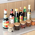 Spice and Condiment Bottles and Jars on Kitchen Counter with Wooden Cabinets and Various Spices
