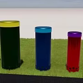 Colorful Cylindrical Musical Instruments and Art Supplies Placed on Grassy Field with Tall Buildings