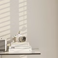 Stylish Ornament Decor Set With Vintage Camera Stacked Books And Retro Speaker On Minimalist Shelf