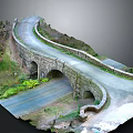 Stone Arch Bridge Model With Curved Road And Green Plant Surroundings
