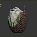 Brown Woven Basket With Two Handles Holding Beige Blanket On Gray Background