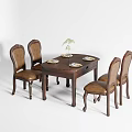 Round Wooden Dining Table Set With Four Leather Upholstered Chairs And Decorative Plant