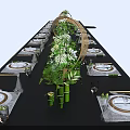 Elegant Banquet Hall Table Setting With Lush Greenery Decorative Wooden Structures And White Plates