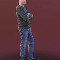 Man In Dark Green Sweater And Blue Jeans Standing With Crossed Arms Against Red Background