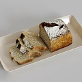 Artisanal Bread Loaf With Flour Dusting And Sliced Pieces On White Rectangular Plate
