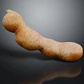 Fresh Ripe Tamarind Fruit with Natural Brown Texture on Dark Surface
