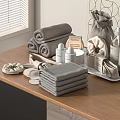 Soft Gray Towels on Modern Bathroom Countertop with Folded and Rolled Stacks and Bath Accessories