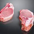 Fresh Raw Meat Cuts With Bone In Pink Color And Fat Marbling On Black Surface
