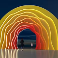 Colorful Gradient Event Entrance With Yellow Orange Red Lights And People Walking Through