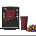 Black DeLonghi Coffee Machine With Red Cup And Fresh Fruit Platter In Kitchen