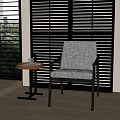 Textured Gray Lounge Chair with Small Round Table Black Louvered Shutters and Greenery View