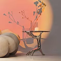 Modern Metallic Side Table With Curved Legs Transparent Vase Yellow Flowers White Candle Beige Sofa