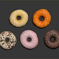 Colorful Donuts With Various Frosting And Sprinkles On Black Sleek Surface