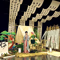 Traditional Chinese Cultural Display with Hanging Calligraphy Scrolls Ancient Costume Figure Pine Lanterns Bamboo Structure