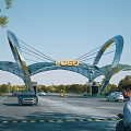 Modern Entrance Gate Design With Curved Glass Structure Logo Cars And Pedestrians