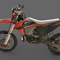 Orange and Black Motocross Motorcycle With Large Off Road Tires And White Seat
