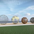 Four Spherical Hollow Design Landscape Sculptures By Waterfront With Blue Sky And Water Reflections