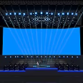 Elegant Stage Setup With Large Blue Screen And Bright Lighting Effects