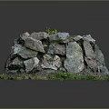 Natural Stone Pile Structure With Green Grass And Small Plant On Top