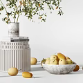 Decorative Ceramic Vase with Plant and Bowl Holding Yellow Fruits on Pedestal and Scattered Fruits