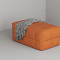 Stylish Orange Upholstered Ottoman Stool With Plush Houndstooth Throw Blanket For Cozy Modern Living Room