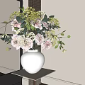 White Ceramic Vase With Pink And Yellow Flowers And Green Leaves On White Shelf