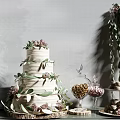 Elegant Tiered White Wedding Cake With Pink Flowers Green Leaves And Desserts Macarons Nuts Candies