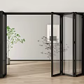 Black Frame Glass Folding Doors Open in Interior with Wooden Floor and Green Plants