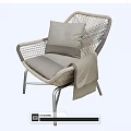 Stylish Rattan Leisure Chair With Metal Legs Gray Cushion Pillow And Draped Blanket