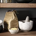 Kitchen Utensils Organized on Wooden Shelves with Black Jug Glass Jars Spices Mortar and Bowls