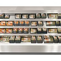 Stainless Steel Display Freezer with Multiple Shelves Holding Various Packaged Foods