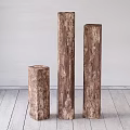 Rustic Stone Wood Logs Piled on Wooden Floor Against Light Colored Wall