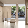 Modern Clothing Store Interior Design With Display Racks Comfortable Sofa And Decorative Plants