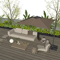 Comfortable Outdoor Sofa With Beige Umbrella And Green Plants On Wooden Deck