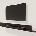 Wall Mounted Black Television With Wooden TV Stand And Soundbar Speakers
