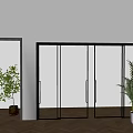 Black Framed Glass and Linen Sliding Doors in Modern Interior With Wooden Floor and Plants