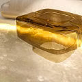 Amber Transparent Glass Side Table With Modern Geometric Design And Sleek Structure