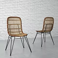 Modern Rattan Leisure Chairs With Black Metal Legs Against White Brick Wall