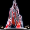 Geometric Red And Silver Art Installation With Star Topped Design And Golden Spheres Base