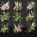 Various Vase Floral Arrangements Featuring Pink Flowers Green Foliage And Succulents