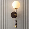 Modern Wall Lamp With White Glass Shade And Gold Metal Accents On Striped Wall
