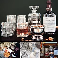 Premium Whiskey Bottles and Glasses with Silver Ice Bucket and Almonds on Dark Table