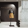 Modern Clothing Store Interior With Fashion Clothes Mannequin Display Racks Vase And Plants