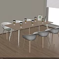 Modern Conference Table With Coffee Cups And White Chairs On Wooden Floor