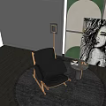 Modern Black Lounge Chair On Wooden Floor With Round Rug Side Table And Portrait